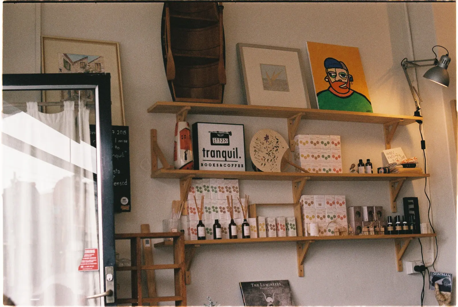 The best cafés to work from in Melbourne Artistic interior of a Melbourne store with a cozy, tranquil vibe, featuring shelves of books and coffee.