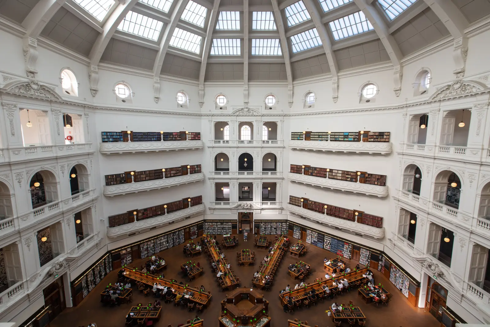 The best places to study in Melbourne, according to Reddit Inside view of the State Library of Victoria featuring a grand domed ceiling and study tables.
