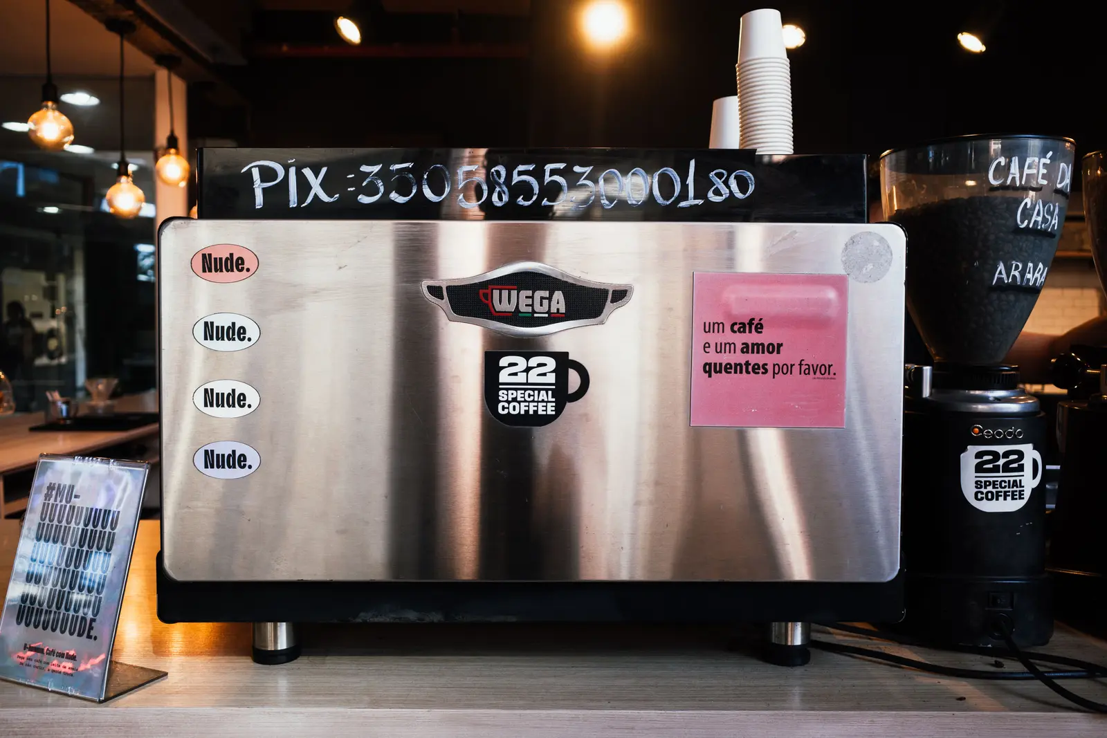 Close-up of a coffee machine adorned with stickers at a café in Rio de Janeiro, Brazil.