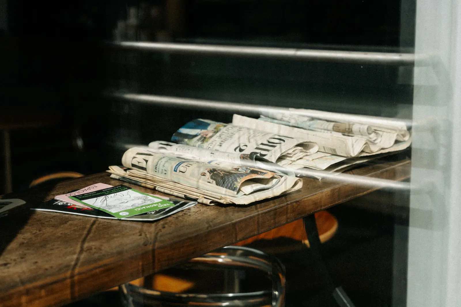 The best cafés to work from in Montreal, according to Reddit A stack of newspapers resting on a cafe table in Montreal, Quebec. Sunlight creating shadows.
