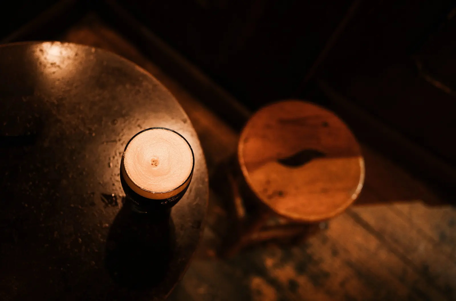 The best cafés to work from in Madrid Warm, inviting atmosphere of a rustic cafe in Madrid featuring a freshly poured beverage on a wooden table.