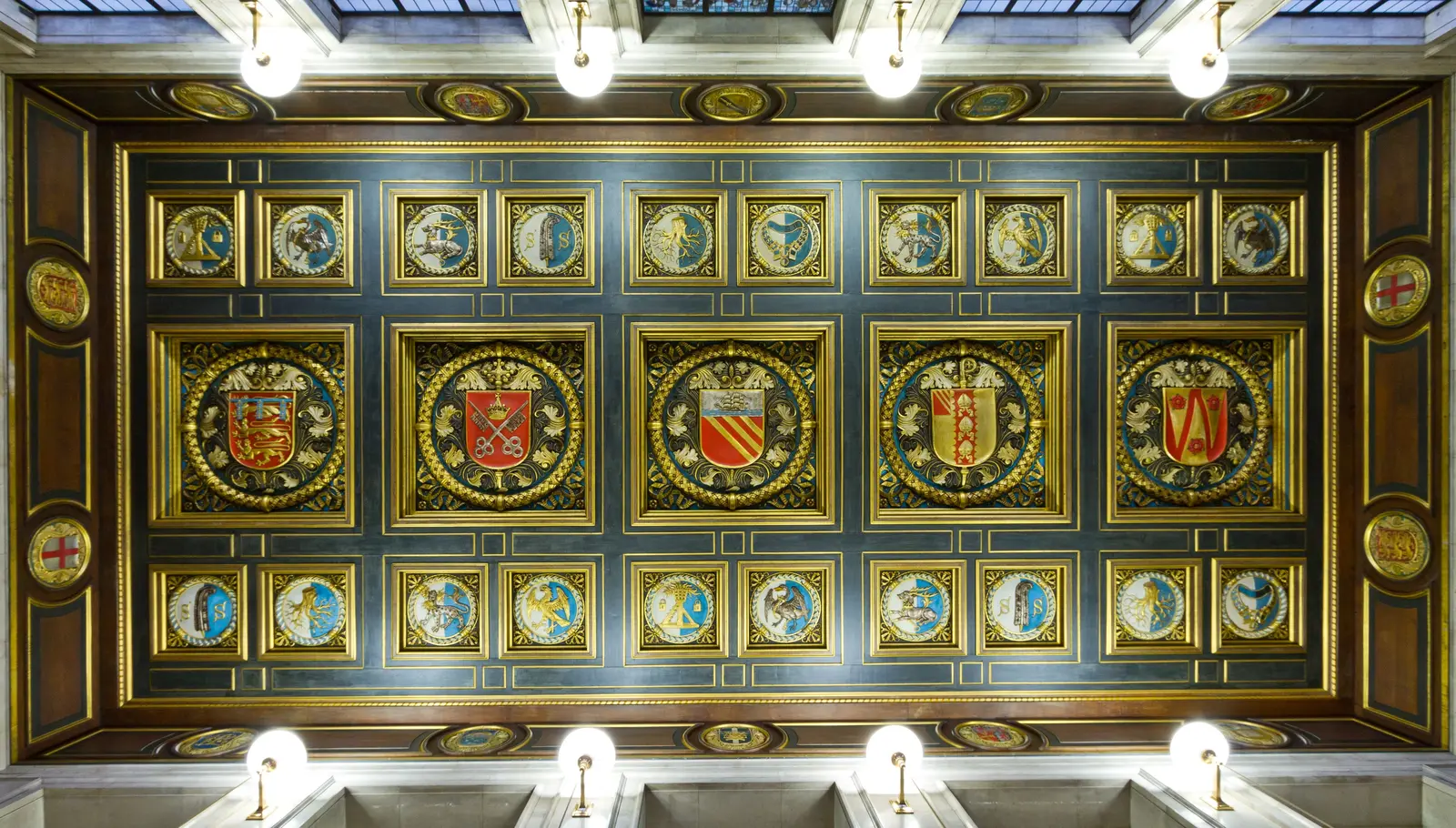 The best libraries to work and study in Manchester Intricately decorated ceiling inside Manchester Central Library, featuring crests and shields.