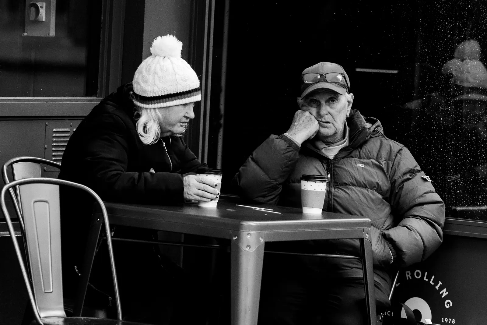 The best cafés to work from in Dublin Black and white photo of two elderly people conversing at a café in Dublin, Ireland.