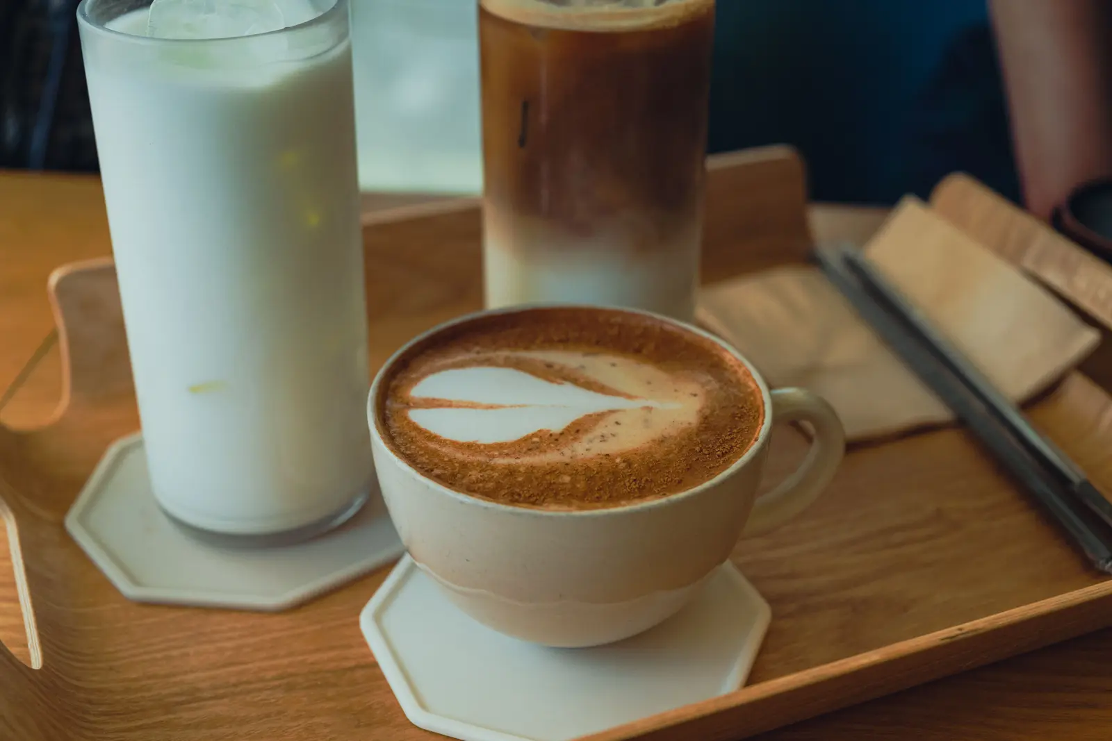The best cafés to work from in Seoul Inviting coffee selection on a wooden tray at a Seoul cafe, showcasing a perfect blend of aesthetics and flavors.