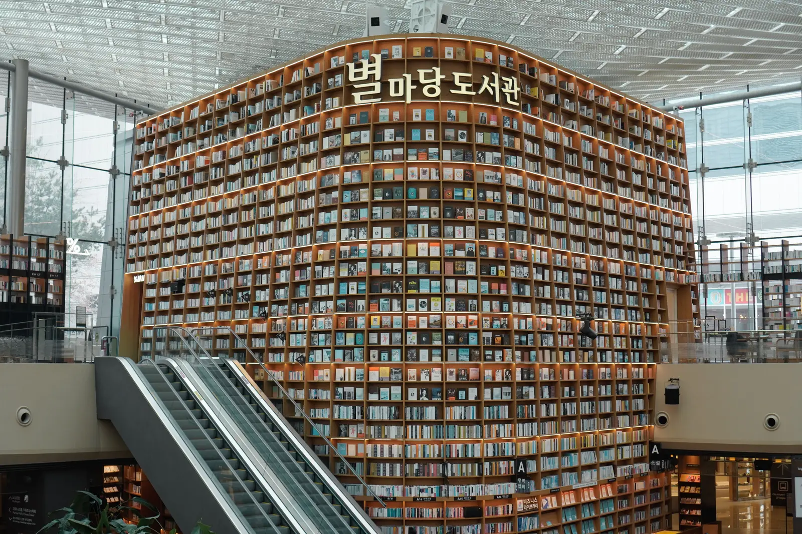 The best libraries to work and study in Seoul Interior view of Starfield Library with towering bookshelves in Seoul's COEX Mall.