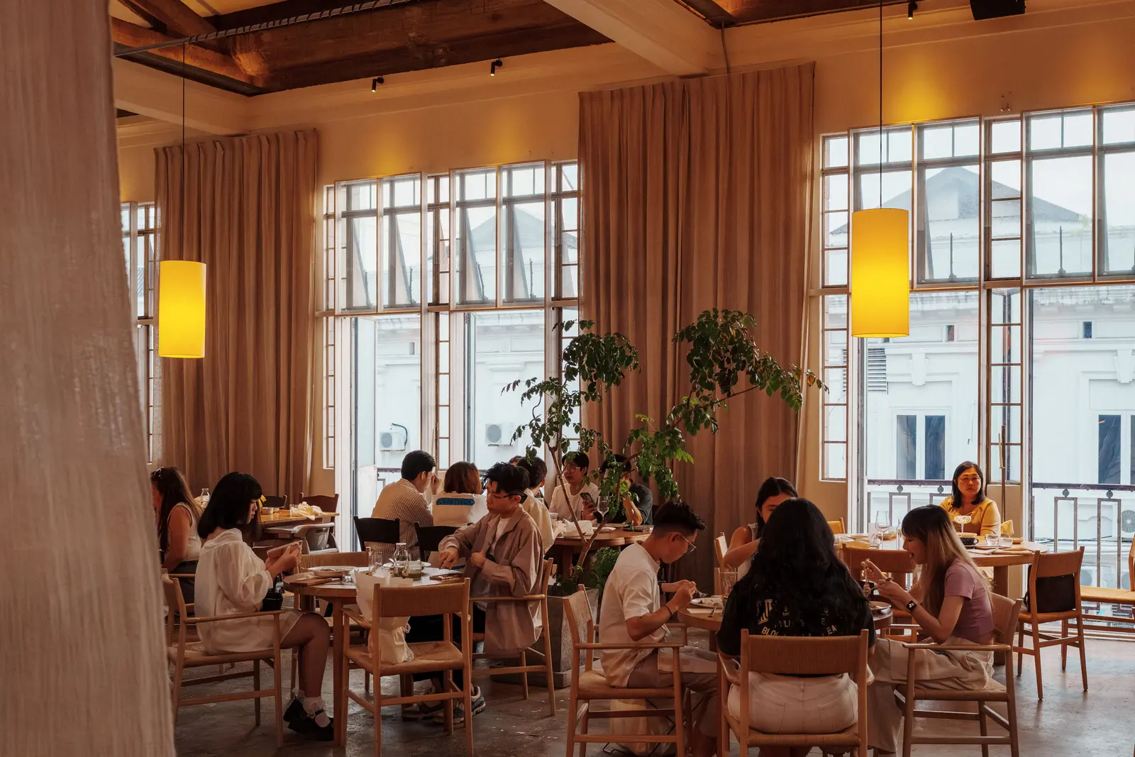 The best cafés to work from in George Town A warm, inviting cafe ambience with people dining in George Town, Malaysia.