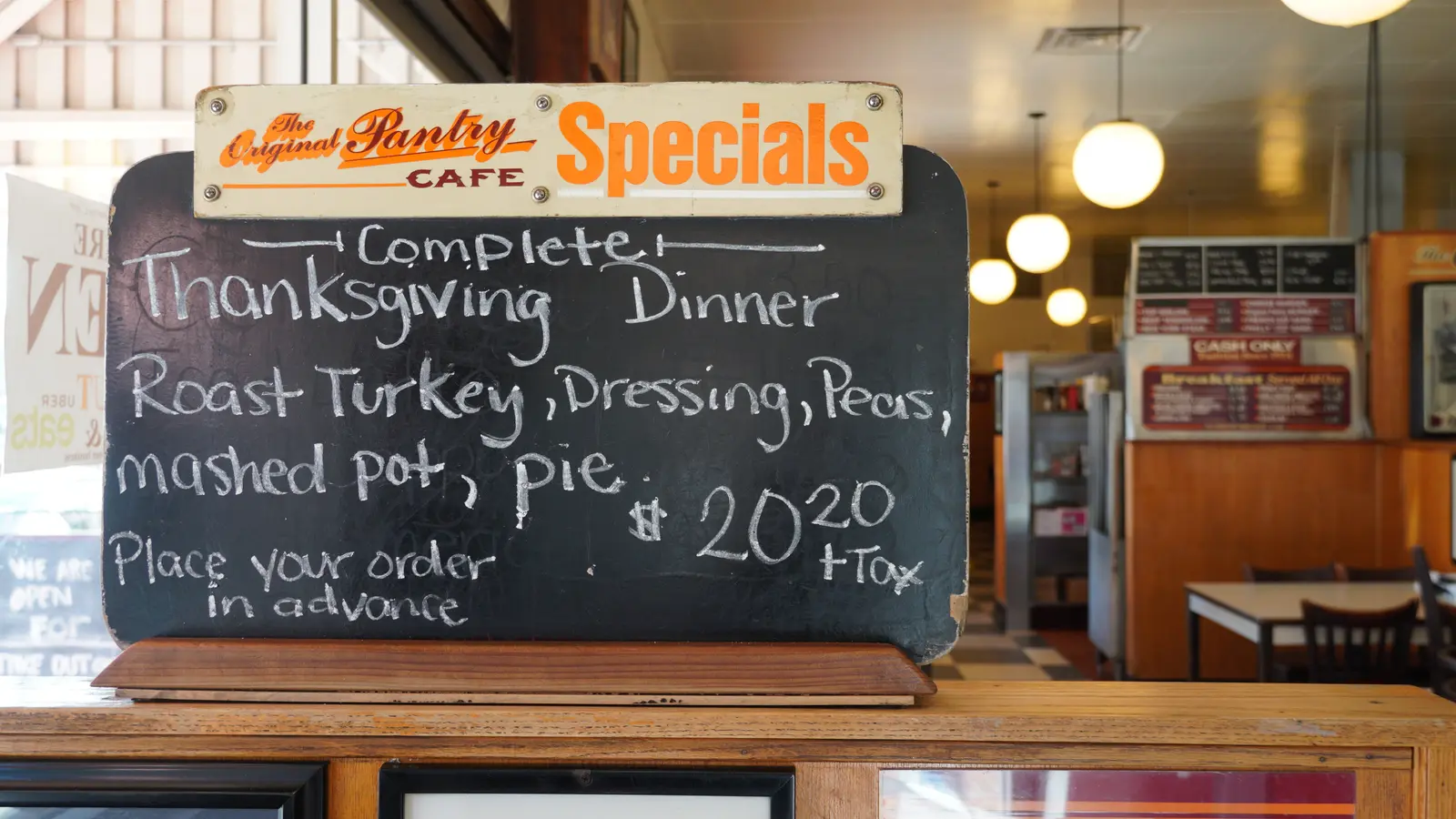 Chalkboard in Los Angeles cafe displays Thanksgiving dinner specials. Warm, inviting atmosphere.