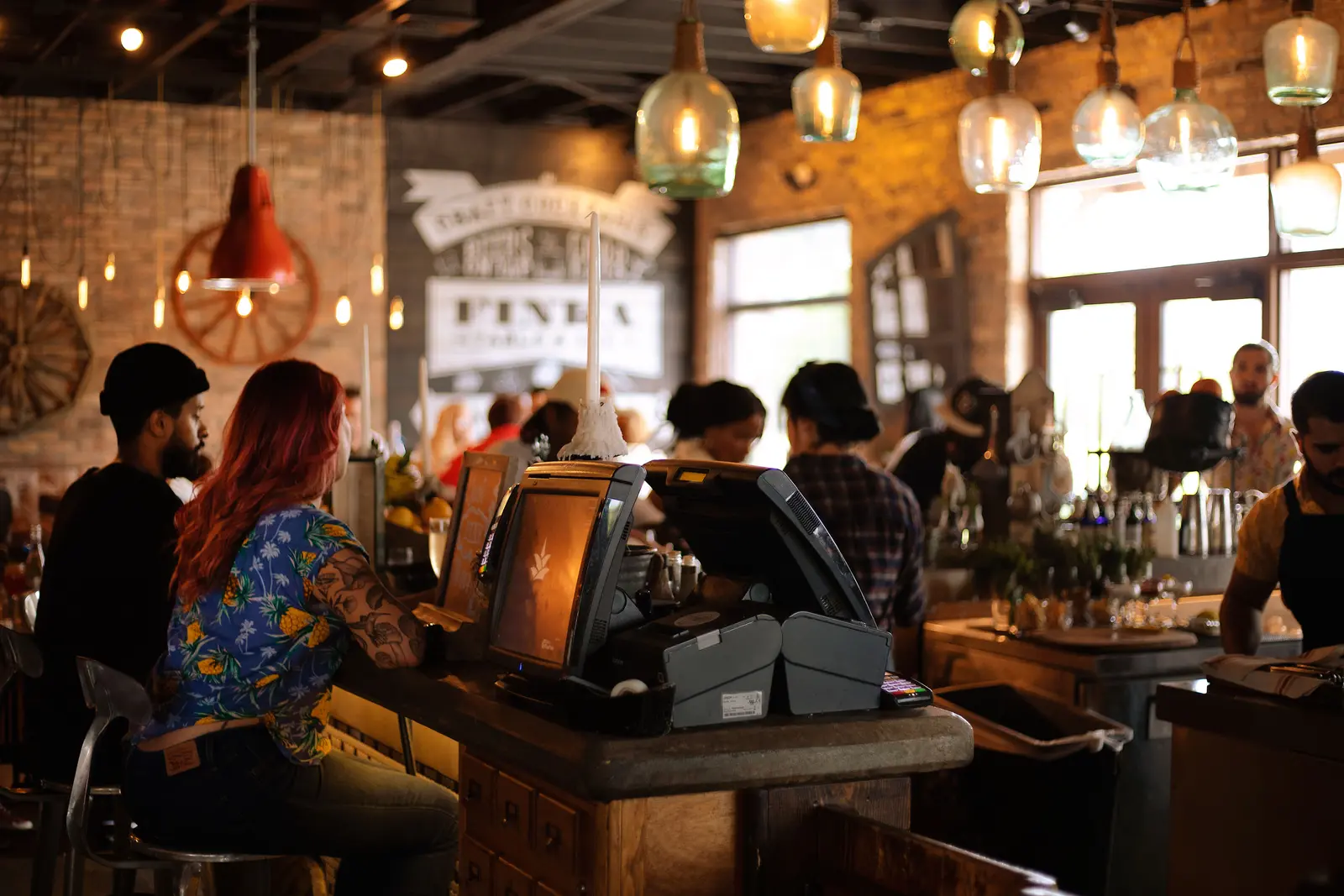 The best cafés to work from in Miami A bustling café in Miami with people enjoying a lively atmosphere and stylish interior design.