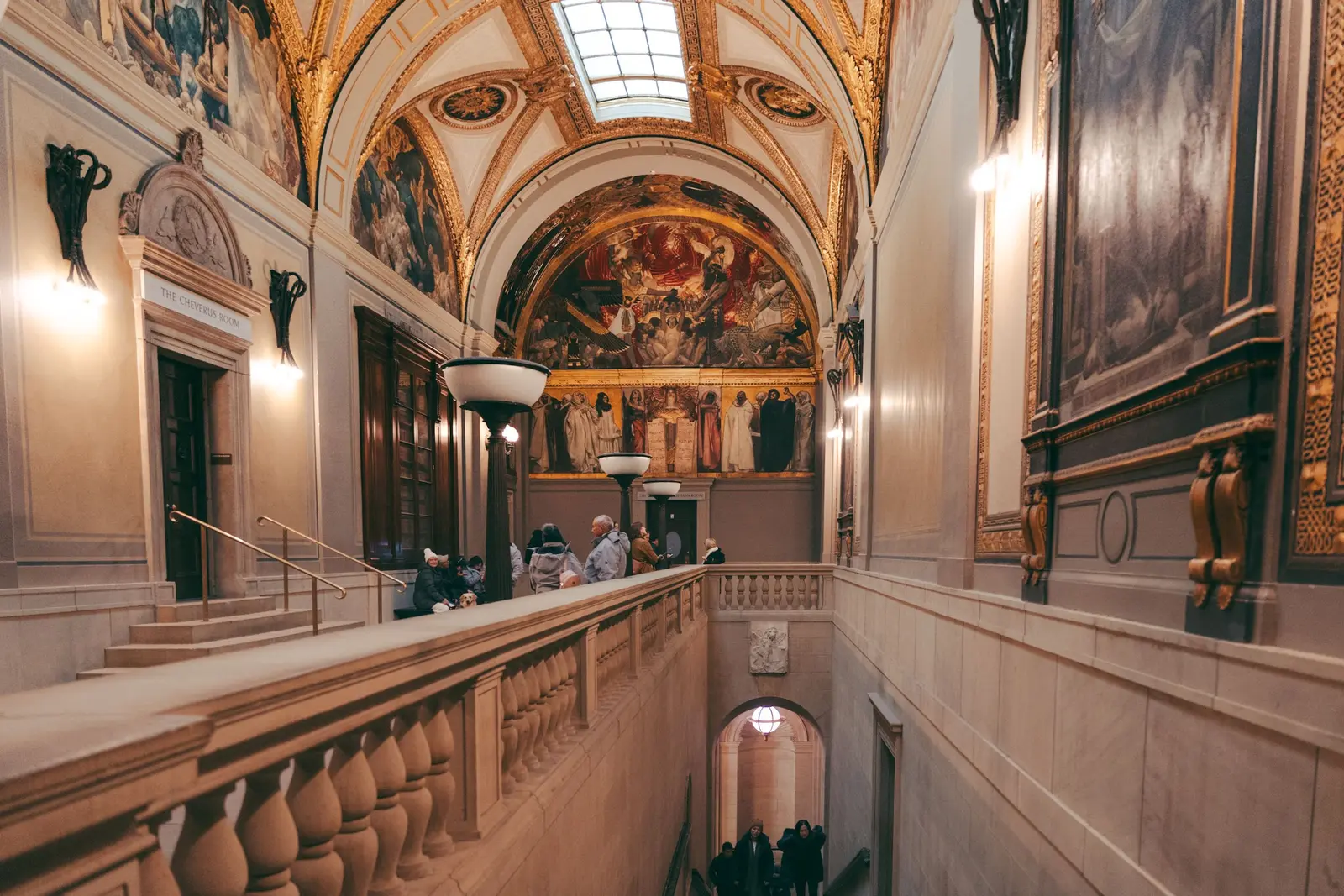 The best libraries to work and study in Boston Ornate interior of the Boston Public Library featuring frescoes and marble.