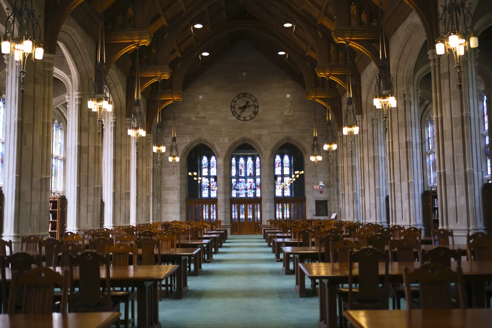 The best places to study in Boston Quiet study area with wooden desks and stained glass in Boston's library.
