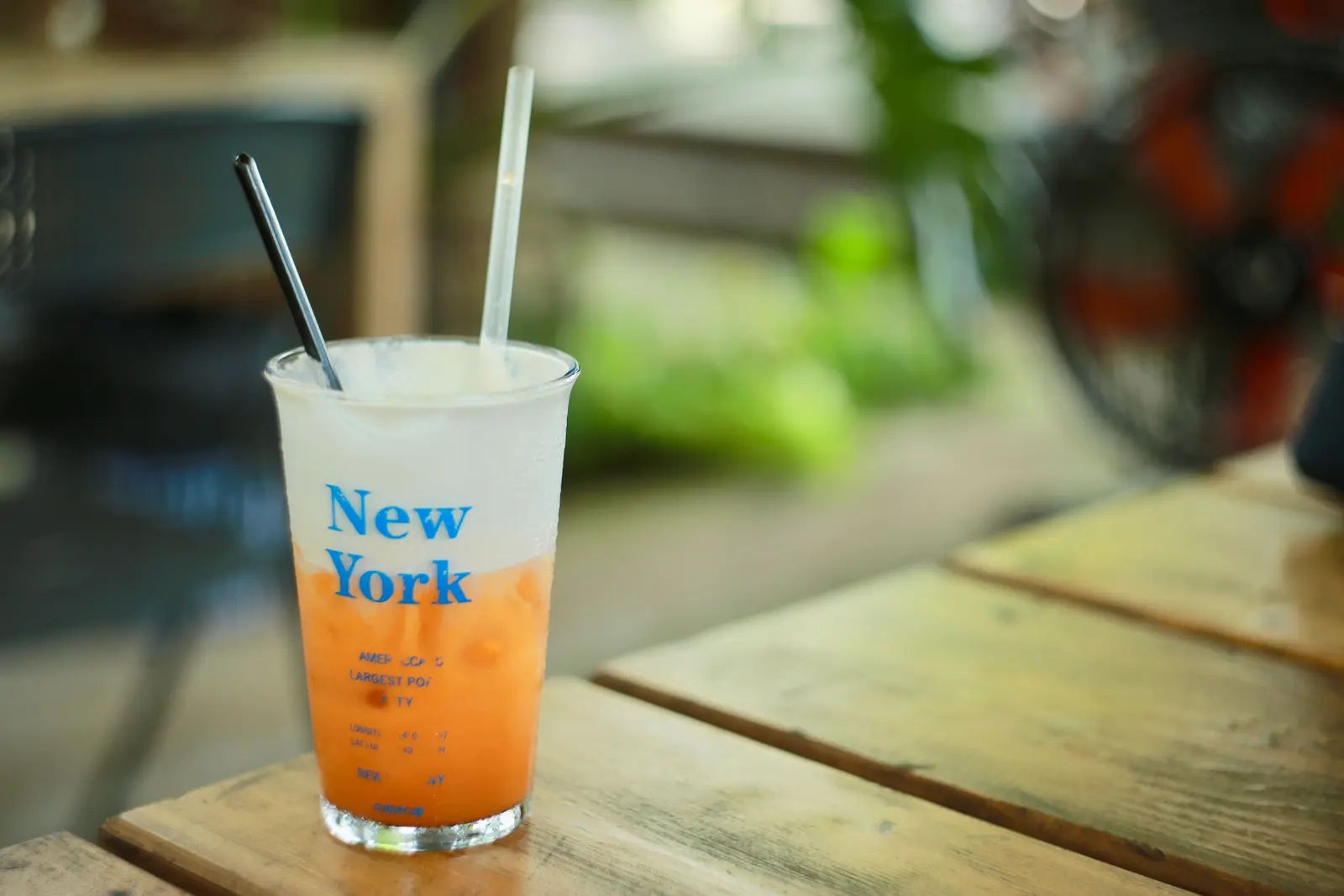 The best cafés to work from in New York Iced drink in transparent cup with New York text on wooden table