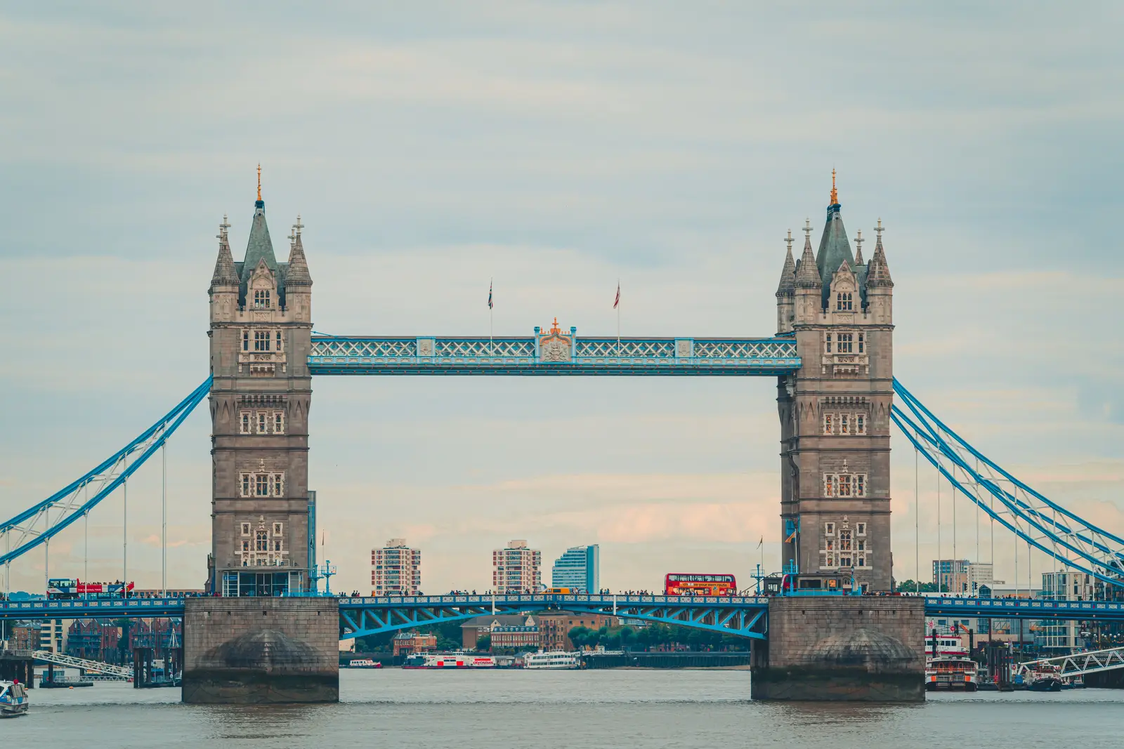 Wide-angle view of London's modern skyline and River Thames under a dramatic sky.