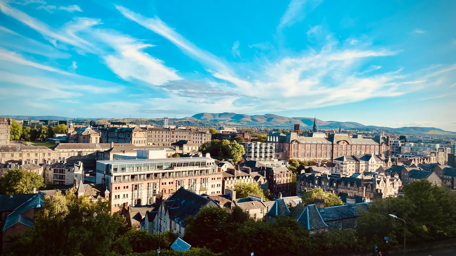 View of Edinburgh's historic architecture against a stunning sunset sky.