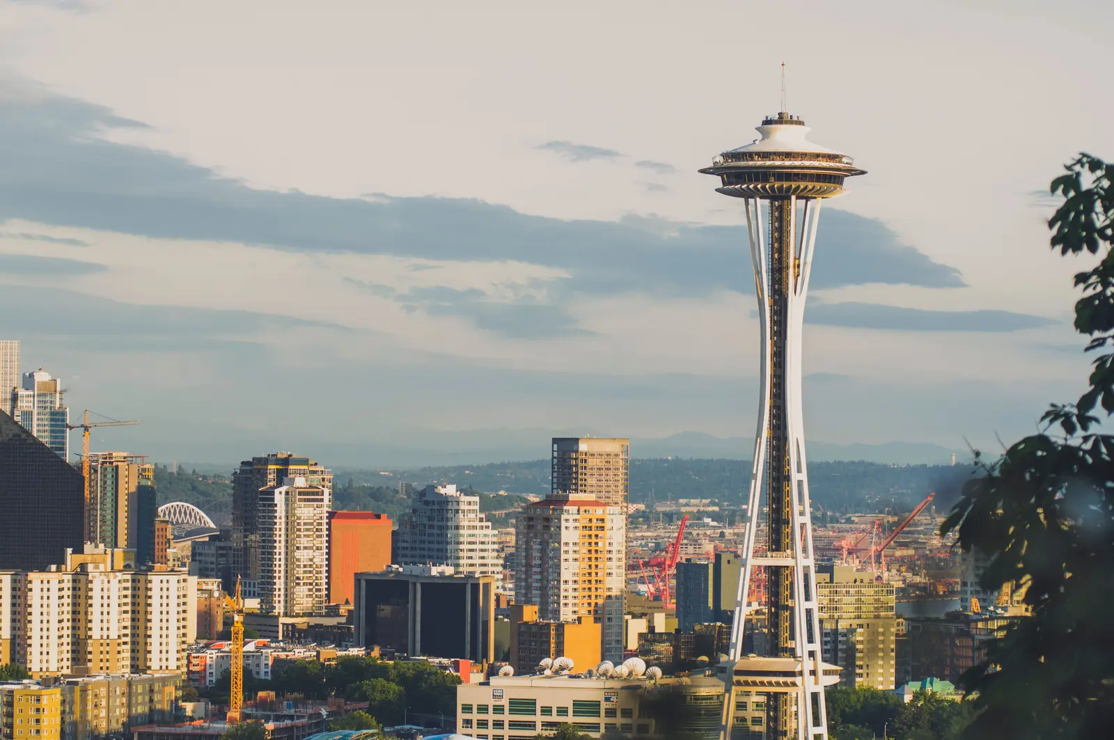 Breathtaking view of Seattle's iconic skyline with the Space Needle and Mount Rainier in the background.